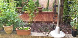Deck installation, creating flower beds, laying chippings and lighting in Ilford, East London